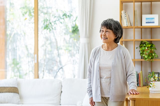リビングに立つシニア女性