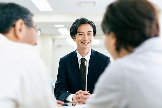 所有権移転登記の手続きを行う男性と夫婦