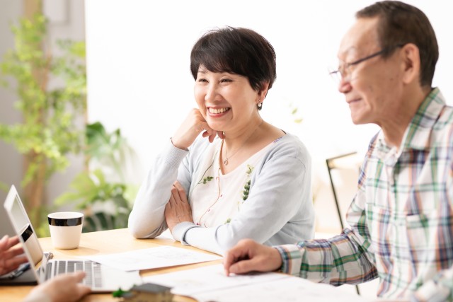 二世帯住宅の売却について不動産会社に質問をする夫婦